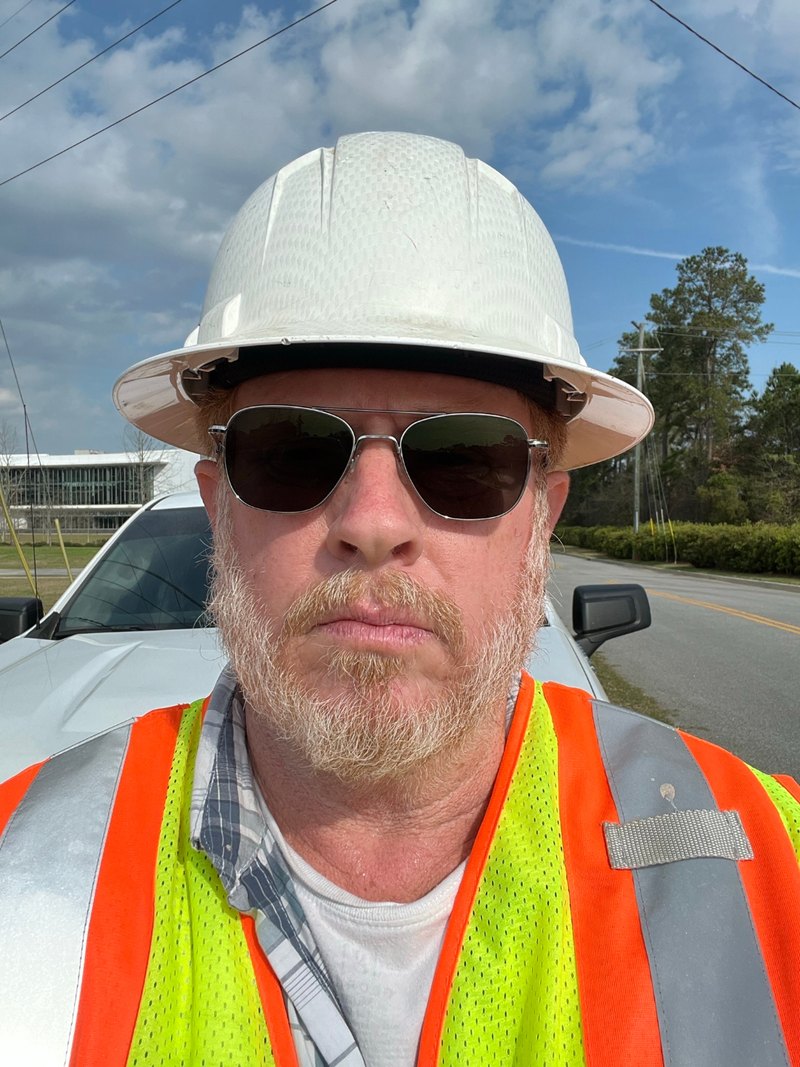 David Self, founder of BlueStake Solutions, on a job site in hard hat and hi-vis vest